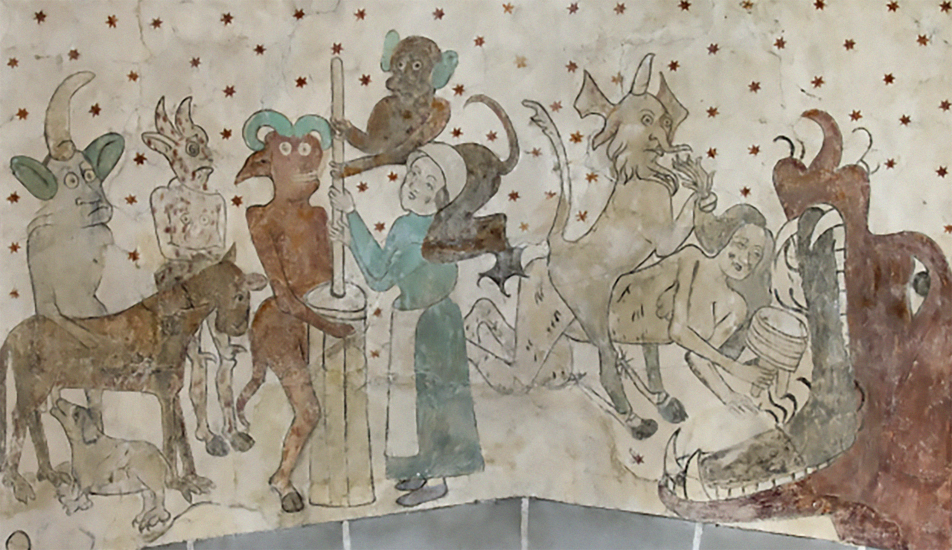 Väggmålning från Öja kyrka. Djävjar hjälper en kvinna att mjälka och kastar en annan kvinna i munnen på ett odjur.